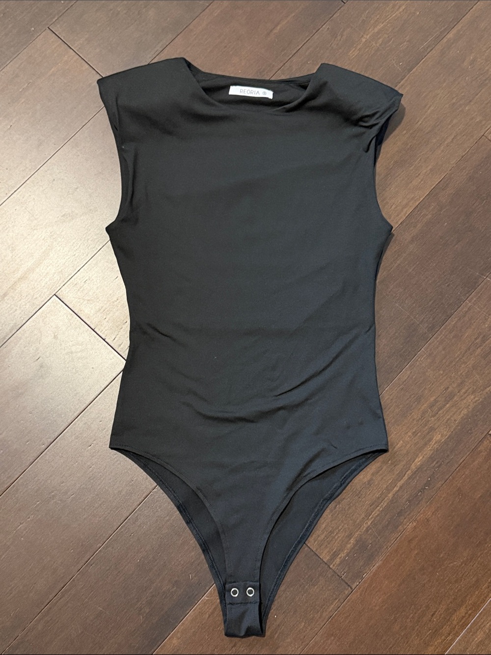 Reoria Black Sleeveless padded shoulders Bodysuit with Snap Closure